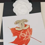 Chanel Gold CC Logo Brooch on Red Maple Leaf